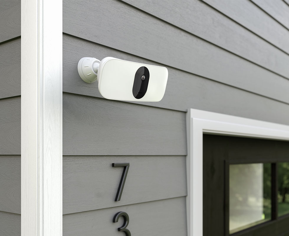 Arlo Pro 3 Floodlight Camera attached to a house by the garage for security