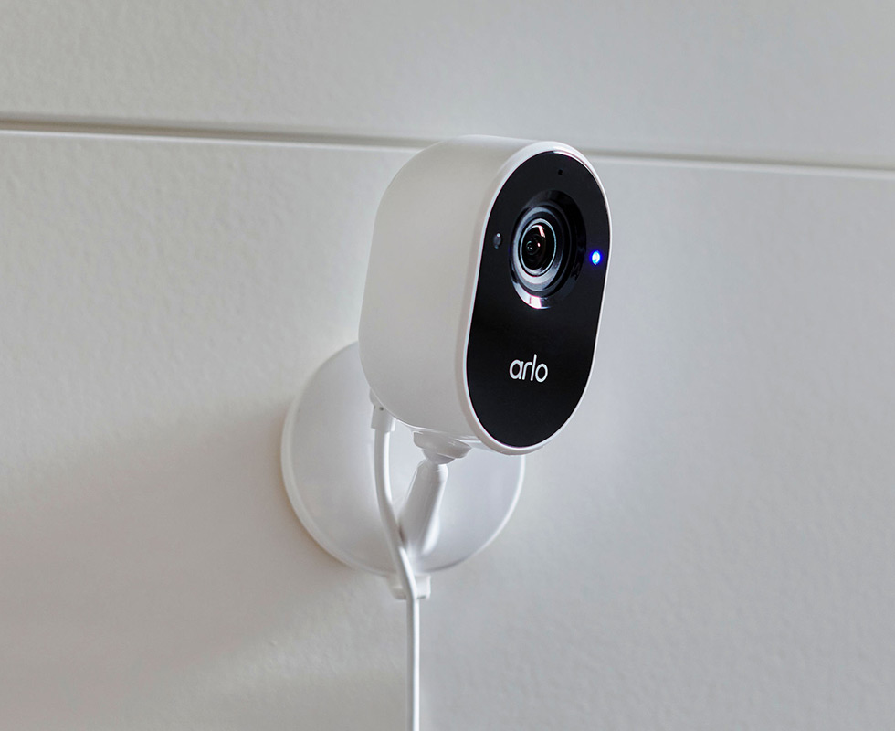 Arlo Essential Indoor security camera mounted to a wall