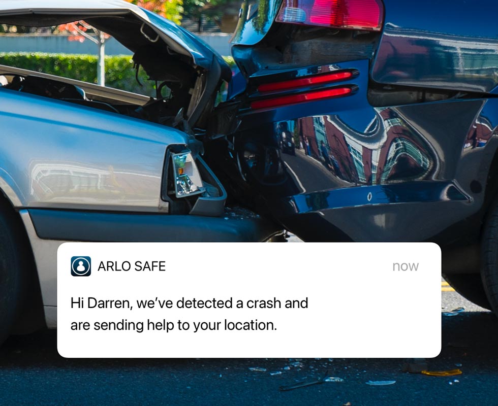 Two cars crashed into each other with an Arlo Safe notification overlayed on top of the image warning of the automotive accident