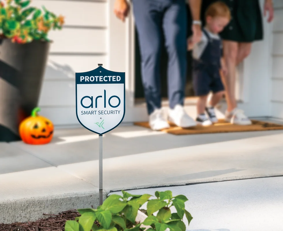 Arlo Yard Sign on the front porch of a house with Halloween decorations.