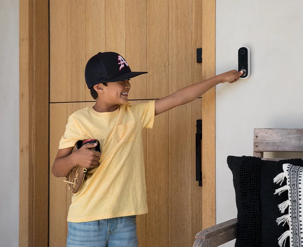 Kid ringing an Arlo 2nd Gen Video Doorbell