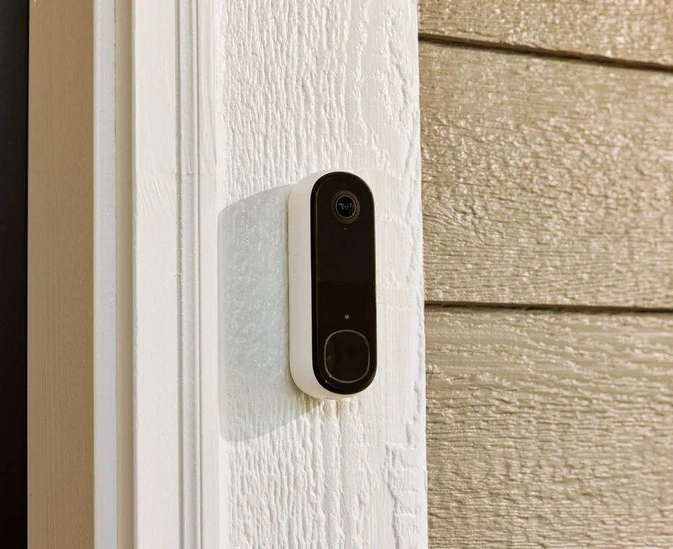 Arlo 2nd generation wireless video doorbell attached to a house