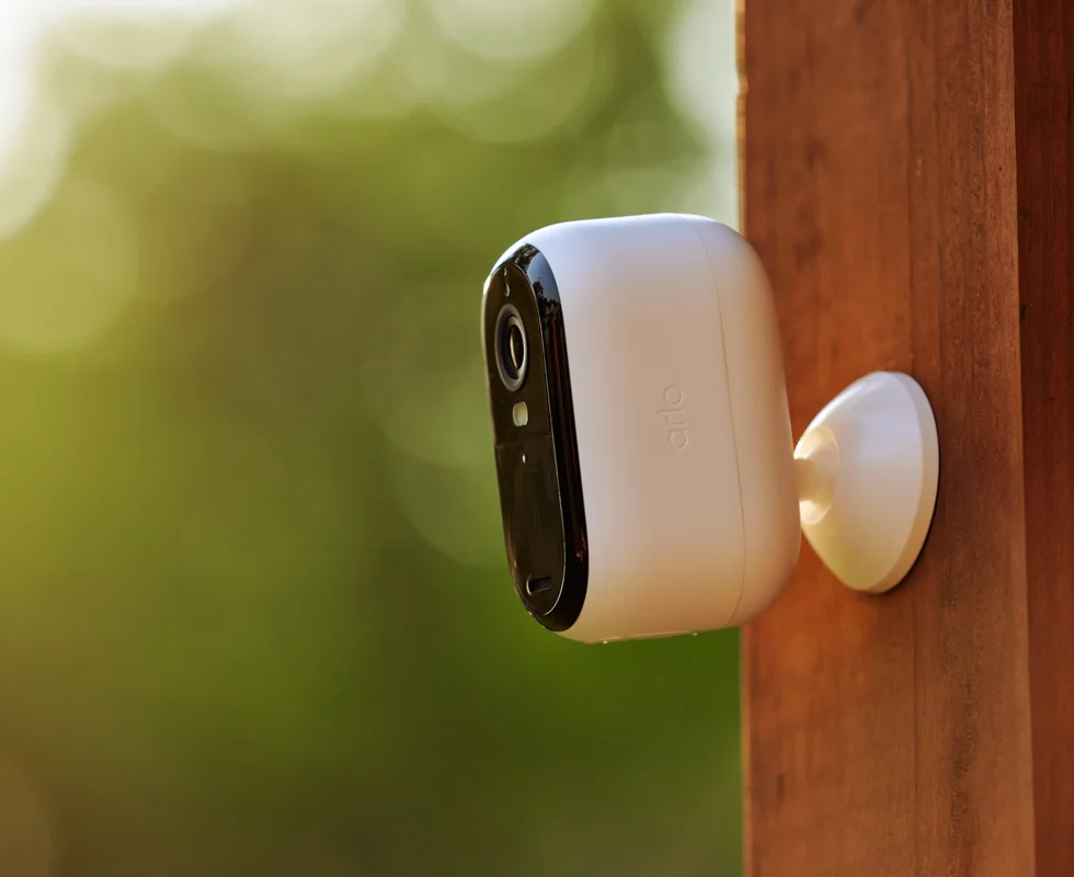 Arlo Essential out door camera mounted on wood