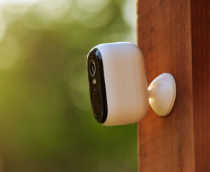Arlo Essential Outdoor camera mounted on wood